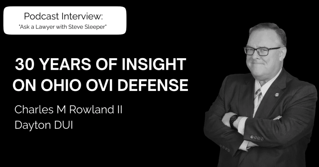 Dayton DUI attorney podcast: Charles M Rowland II in a suit with his arms crossed